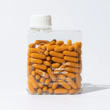 Load image into Gallery viewer, Clear container filled with orange capsules labeled 'Tonik Turmeric Curcumin' on a white background